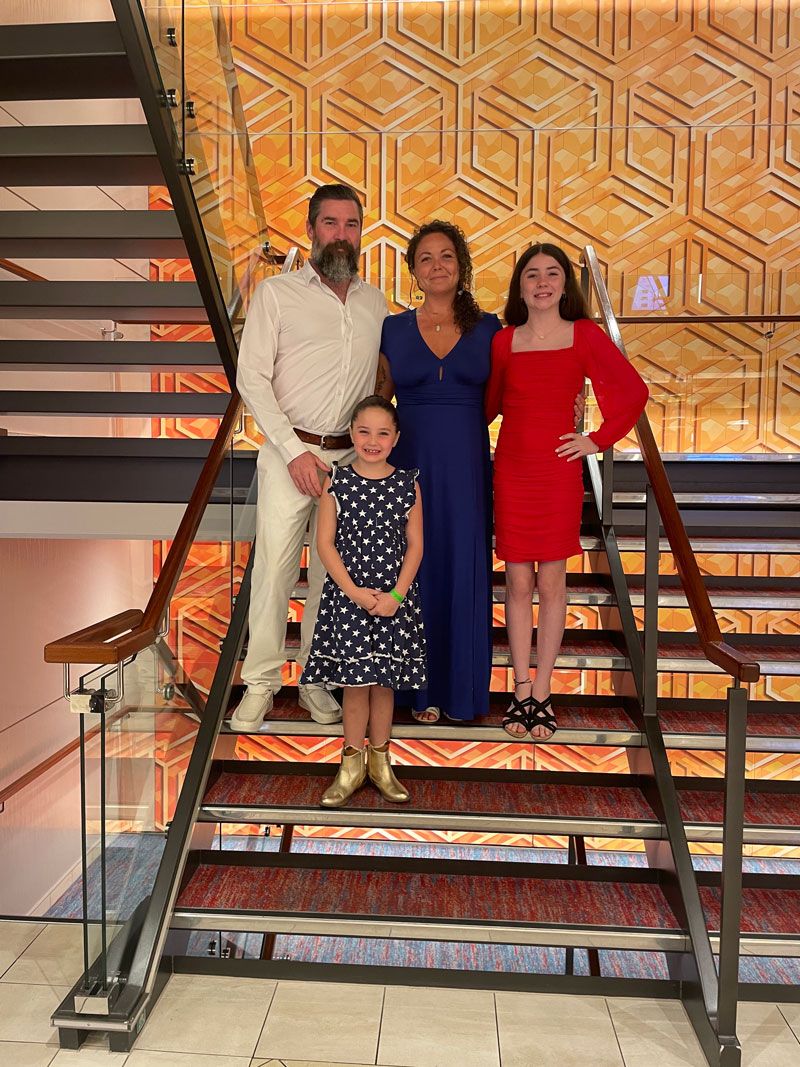 family of four posing on steps