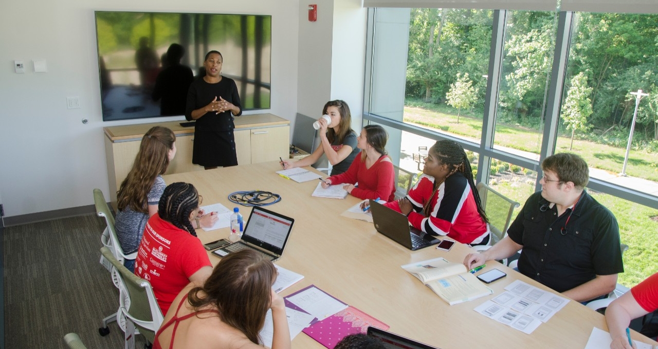 Students listening to professor in a classroom setting 