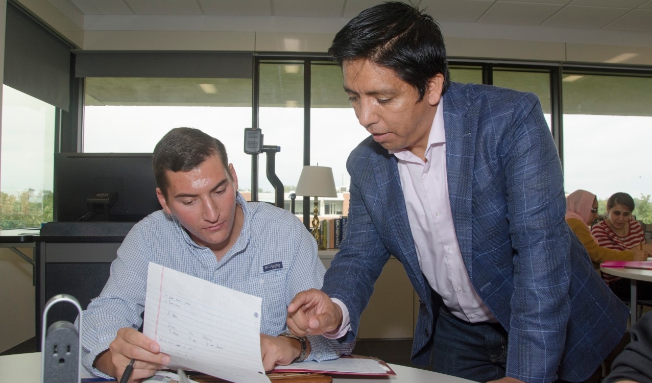 Professor collaborating with student in the classroom