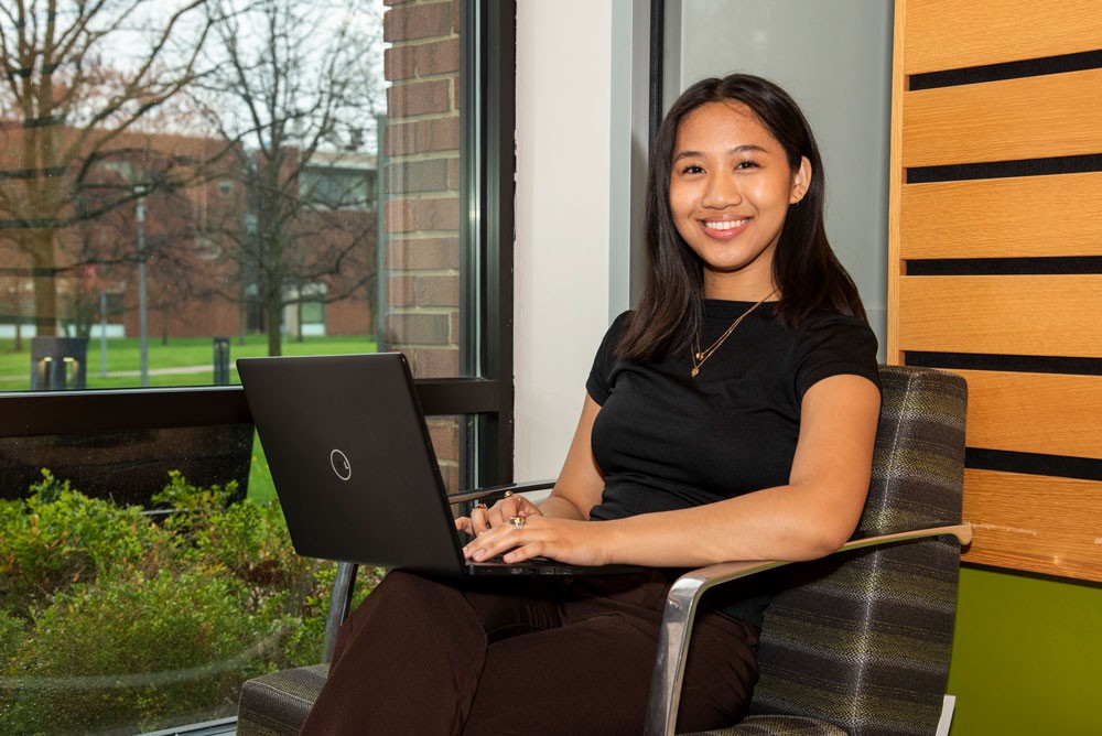 Chai Risma sitting by a window