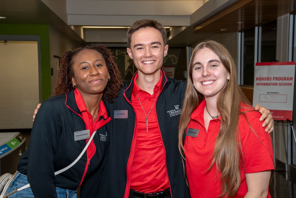 group of three smiling students