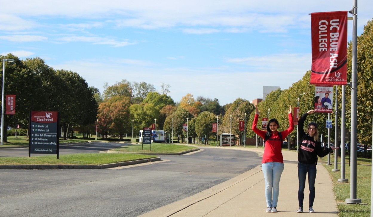 Students holding up hands to create "UC"