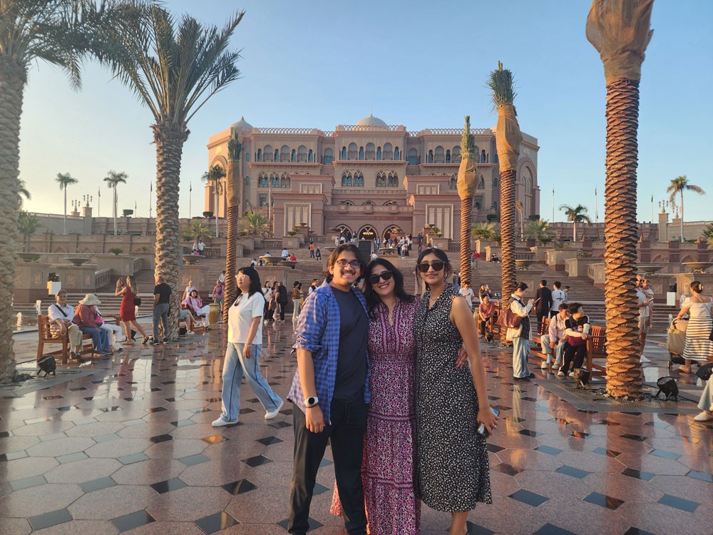 family posing in front of Abu Dhabi palace