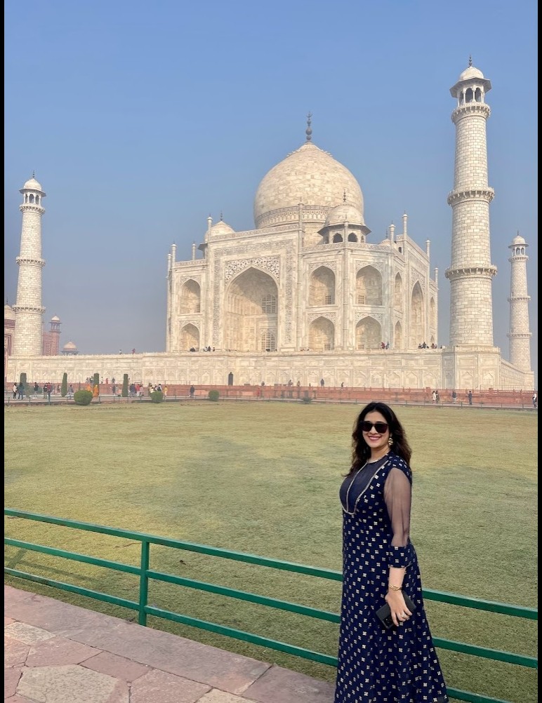 woman posing in front of the Taj Mahal