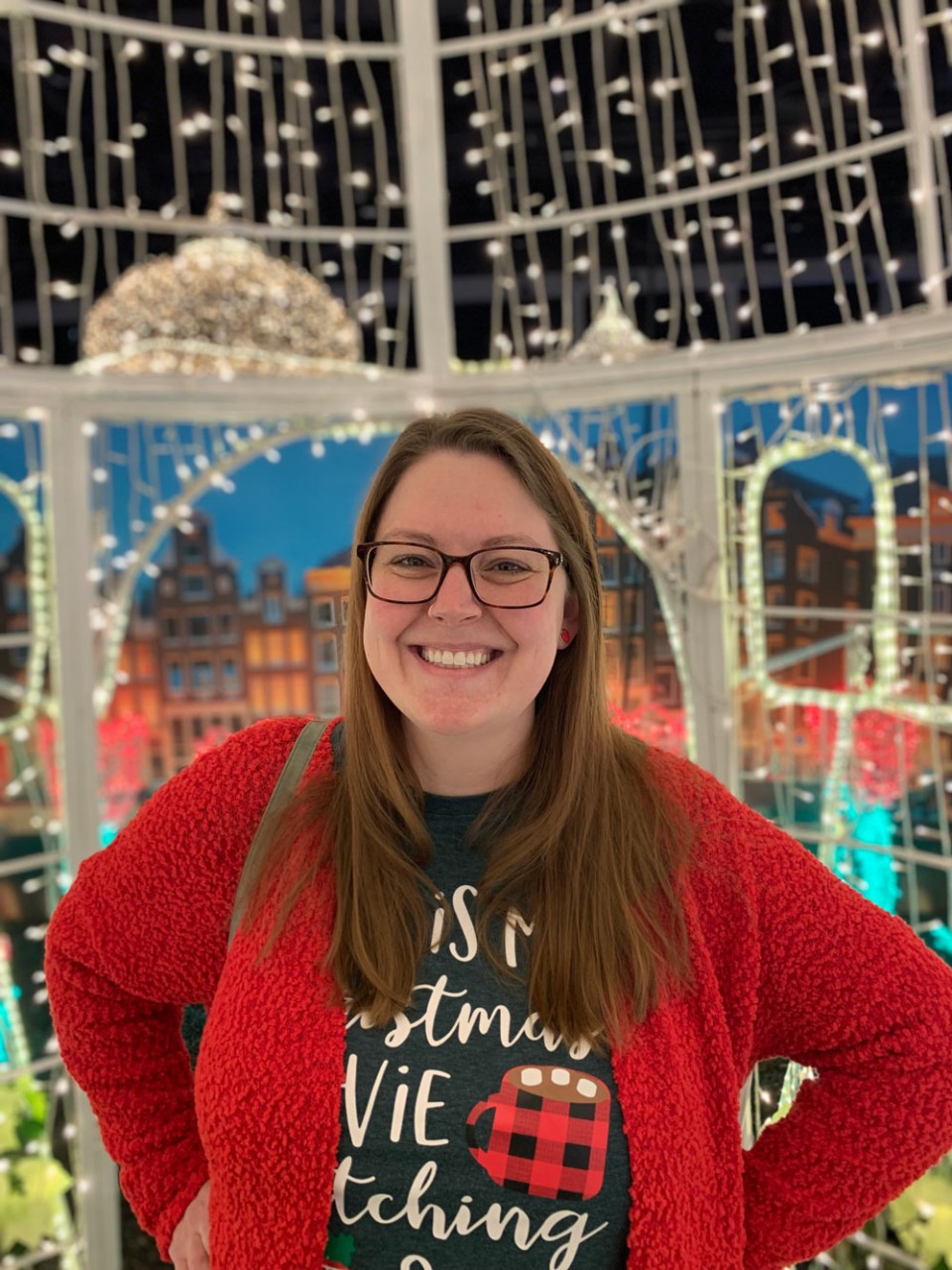 Aleia Whit eposing in front of Christmas lights