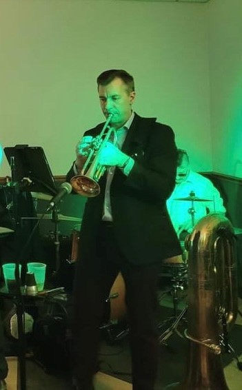 Andy Baker playing the trumpet on stage