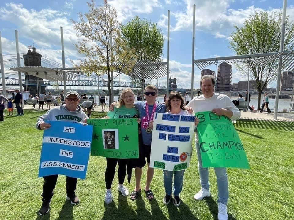 family group posing with congratulations signs