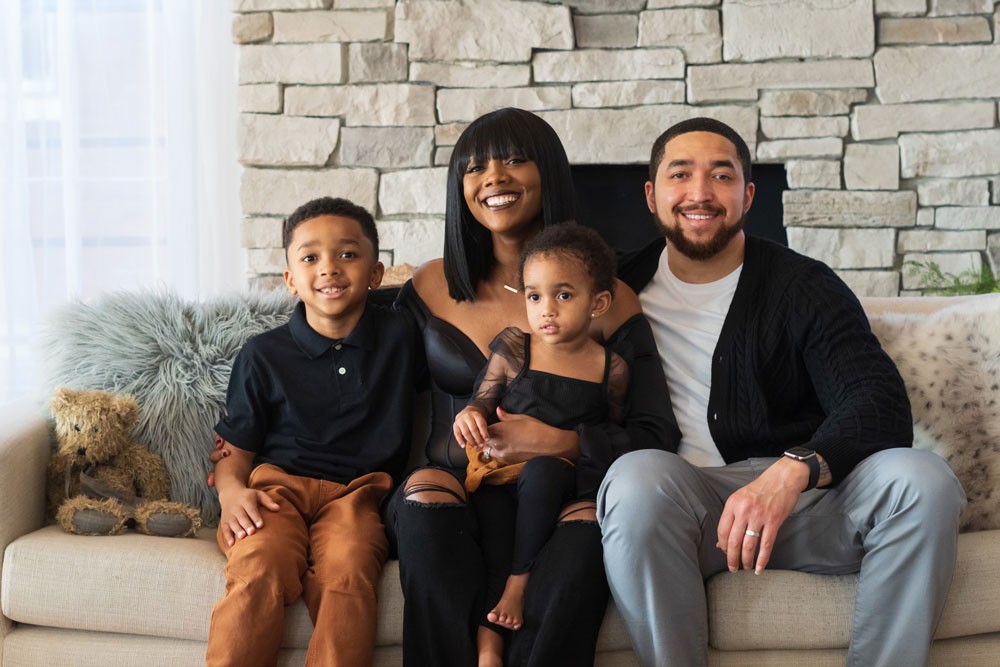 Cortney Matthews with husband and two children on couch