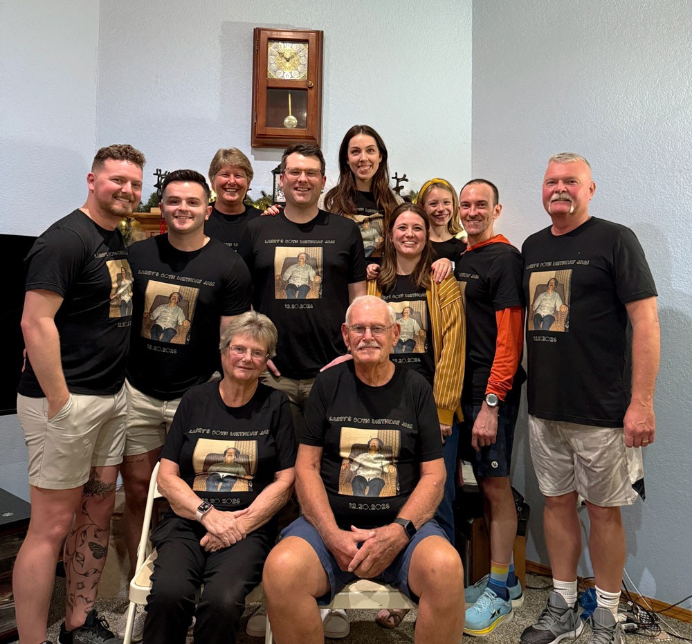 large family group posing with matching t-shirts