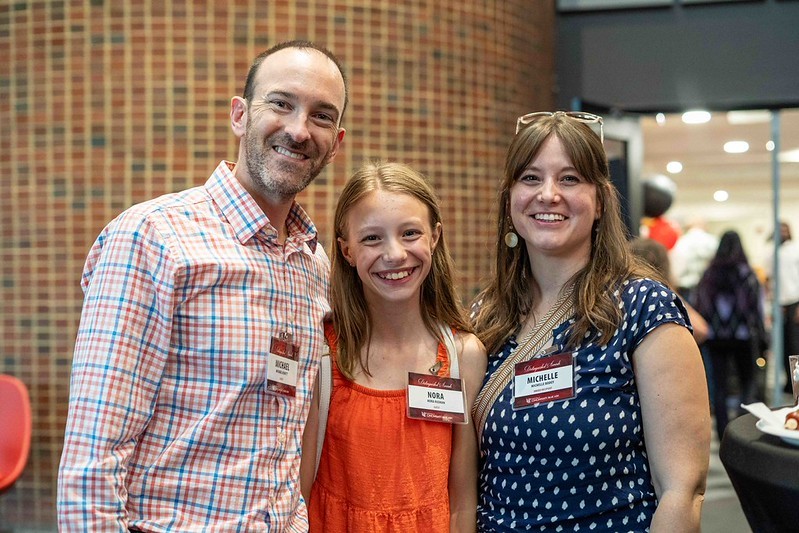 family of three people smiling