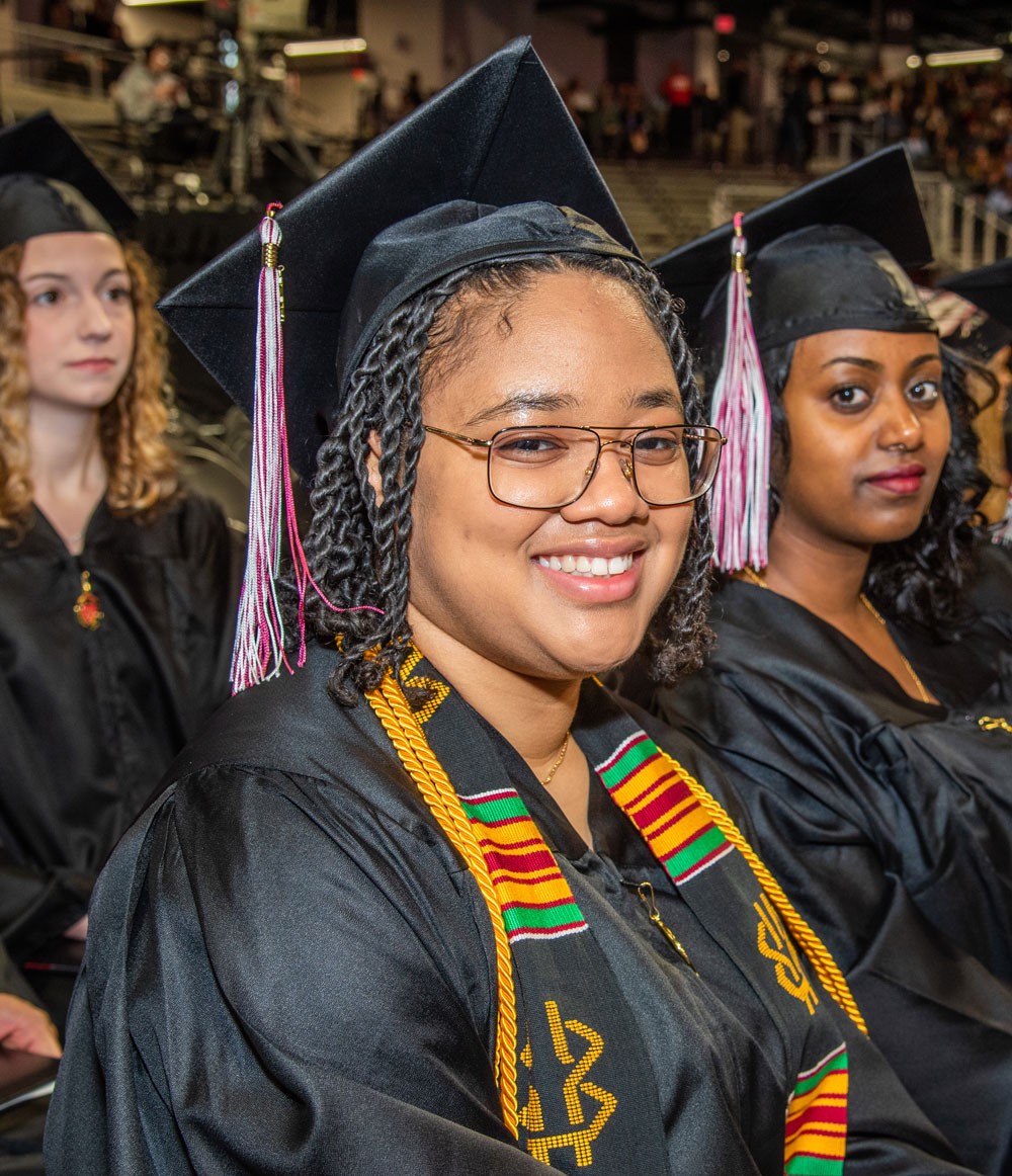 Briana James in robe and gown at commencement