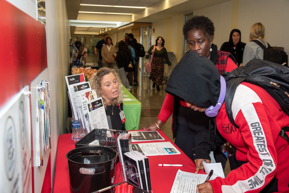 Students meeting with potential employer at career fair