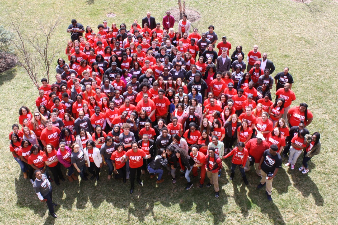 Aerial photo of large student group in red and black t-shirts